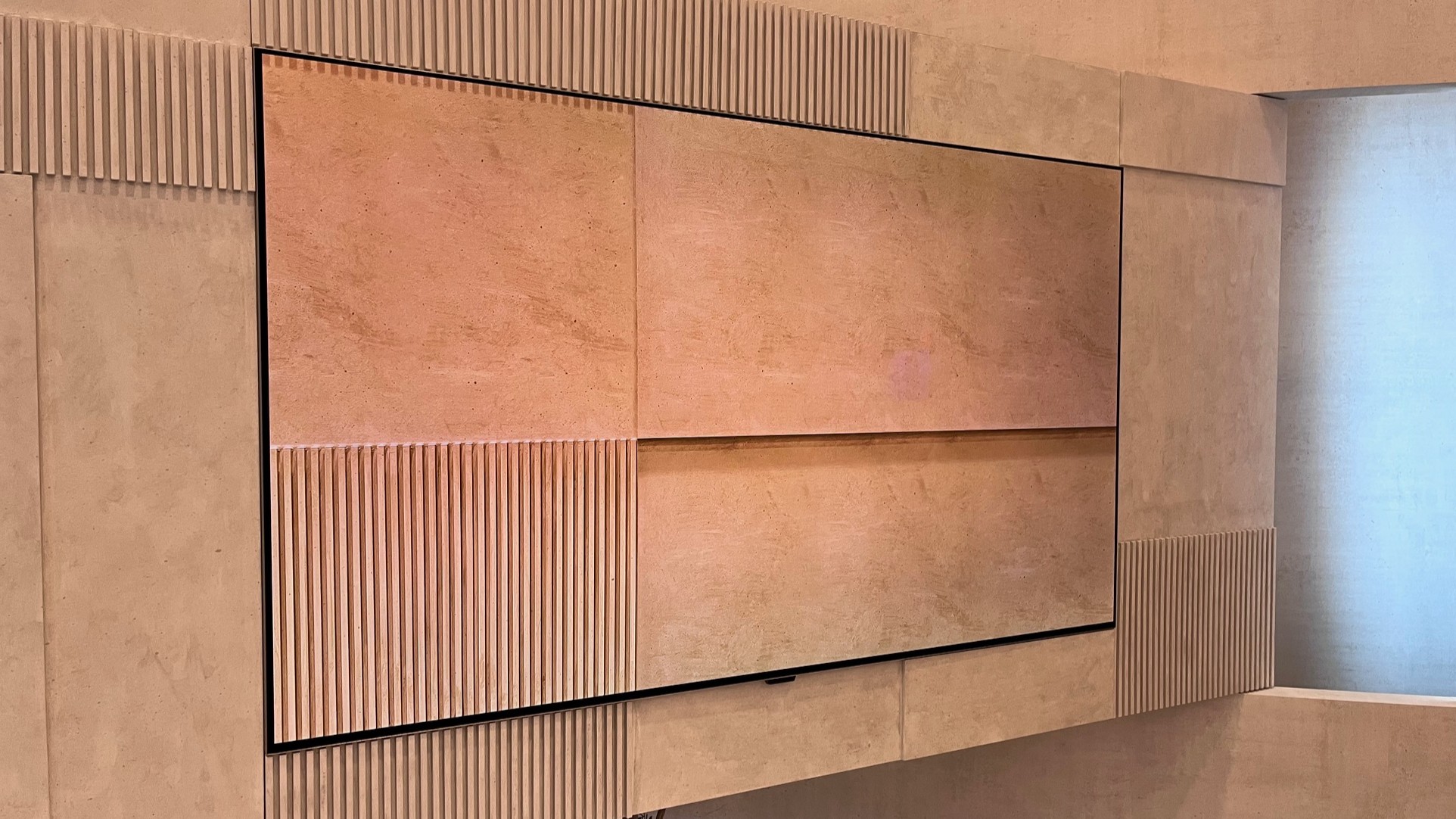 A side-profile view of the LG OLED W6 mounted perfectly flat against a wall surface.