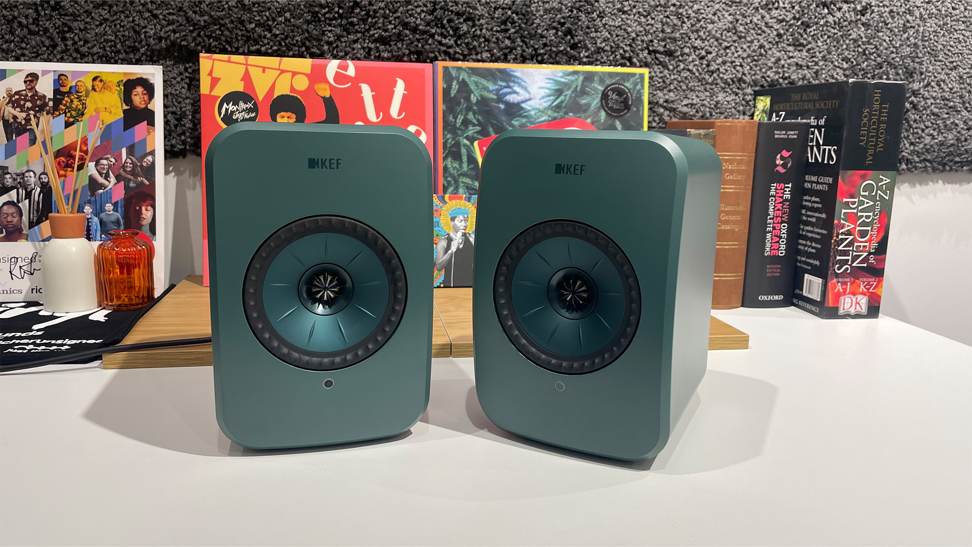 A pair of sage green KEF LSX II LT wireless speakers.