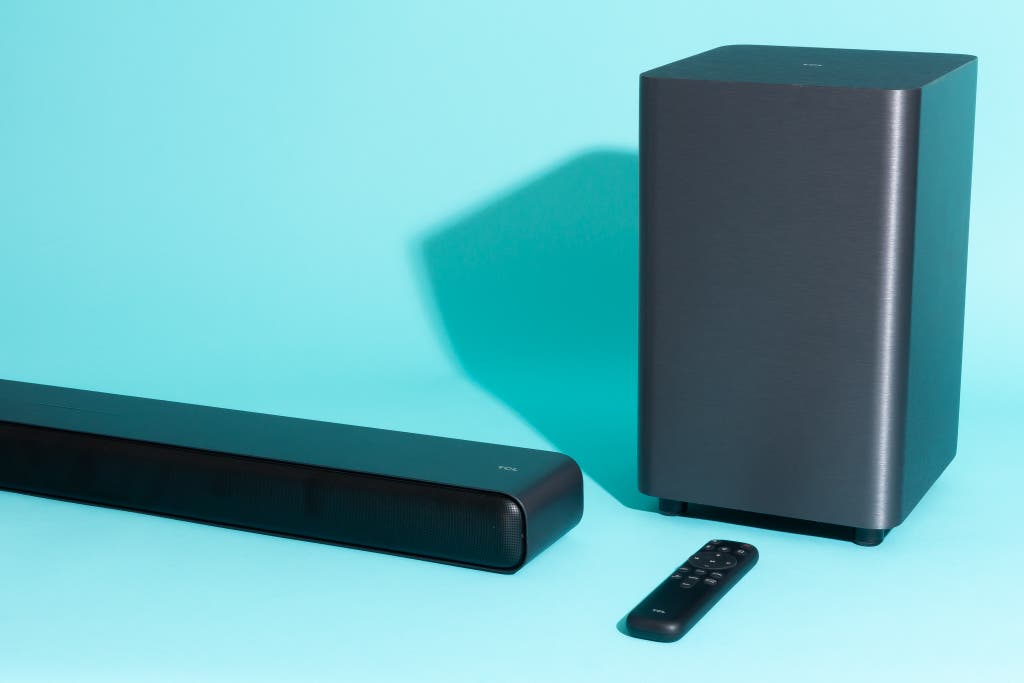 TCL S55H soundbar paired with its vertical subwoofer and remote control.
