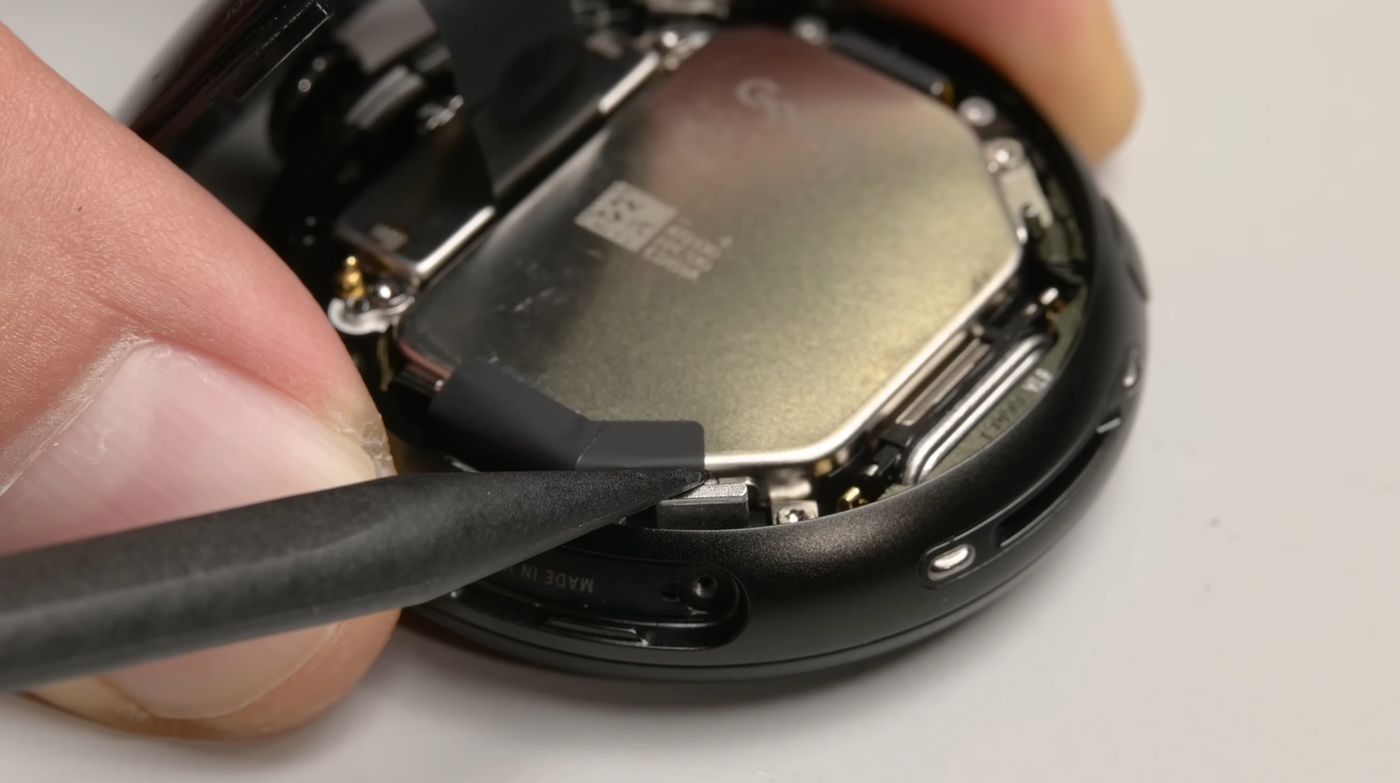 iFixit teardown view showing the clean separation of the Pixel Watch 4 screen from the body.