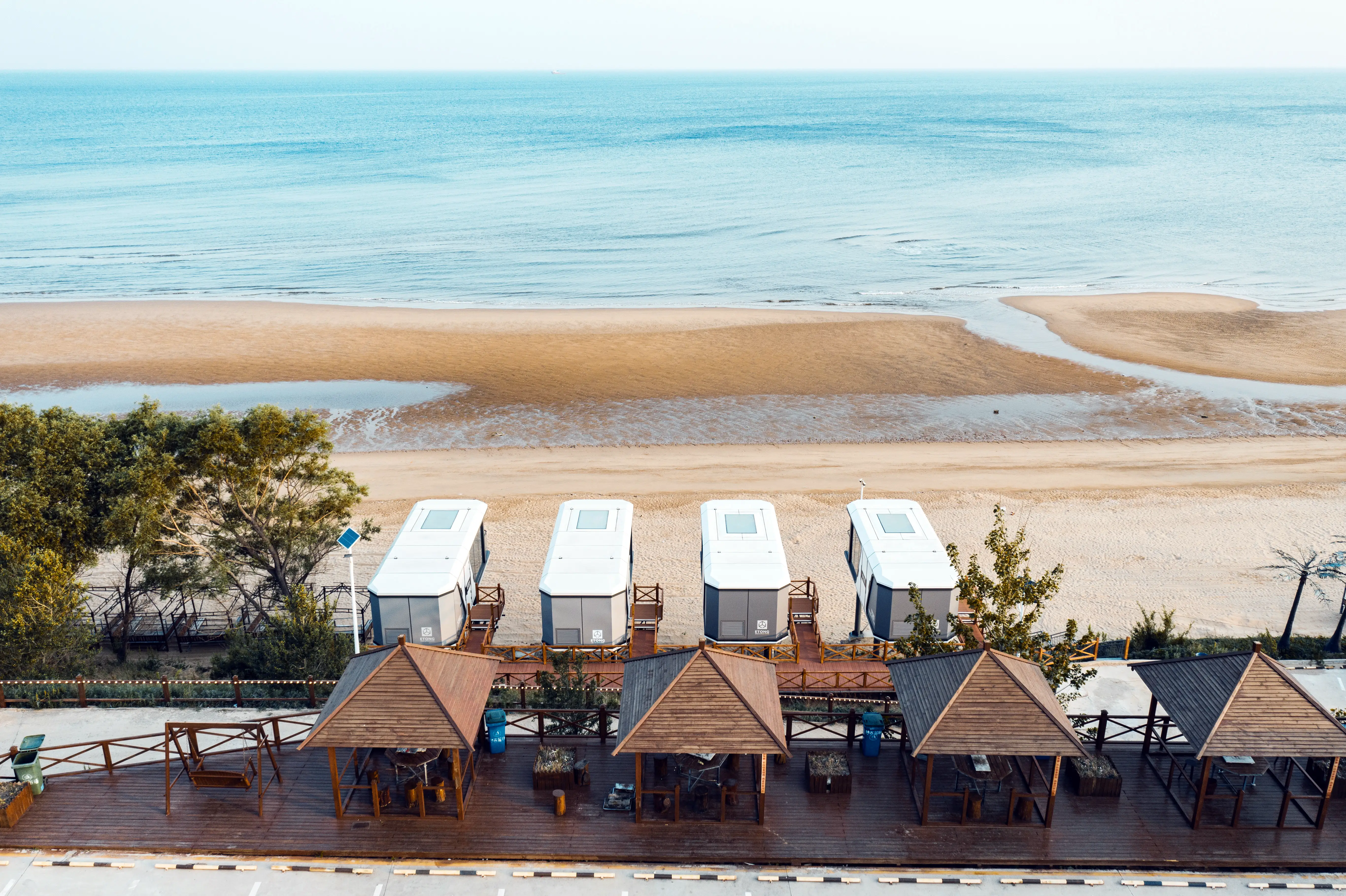 A futuristic white capsule home with high-performance thermal and sound insulation.