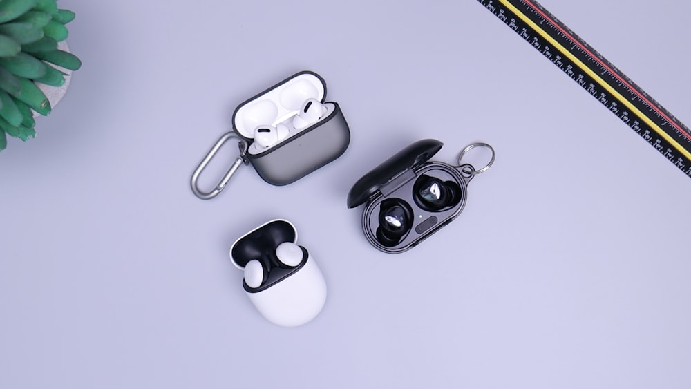 A pair of white wireless earbuds placed on a flat surface.