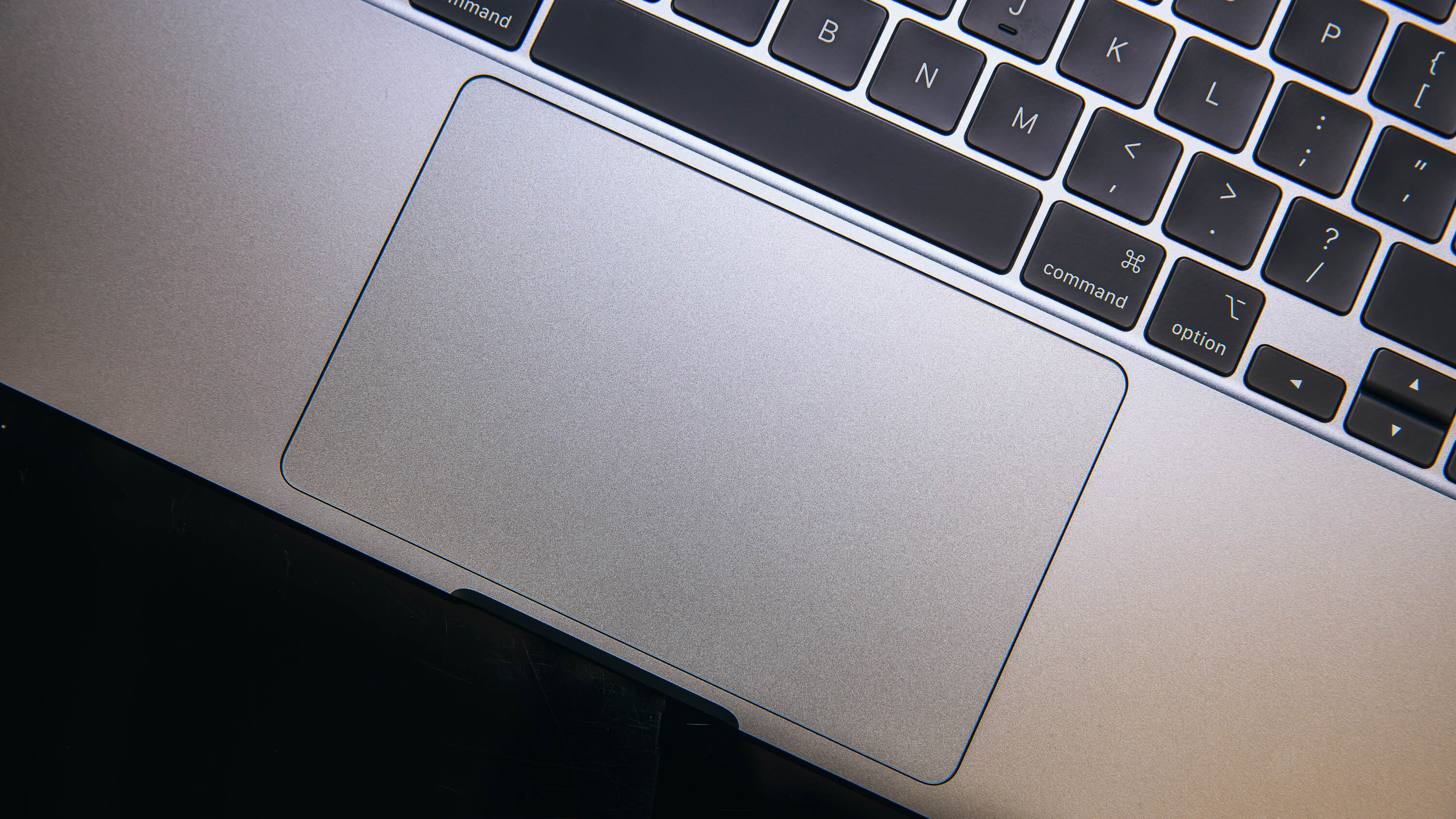 Close-up detail of the MacBook Air Magic Keyboard and haptic trackpad.