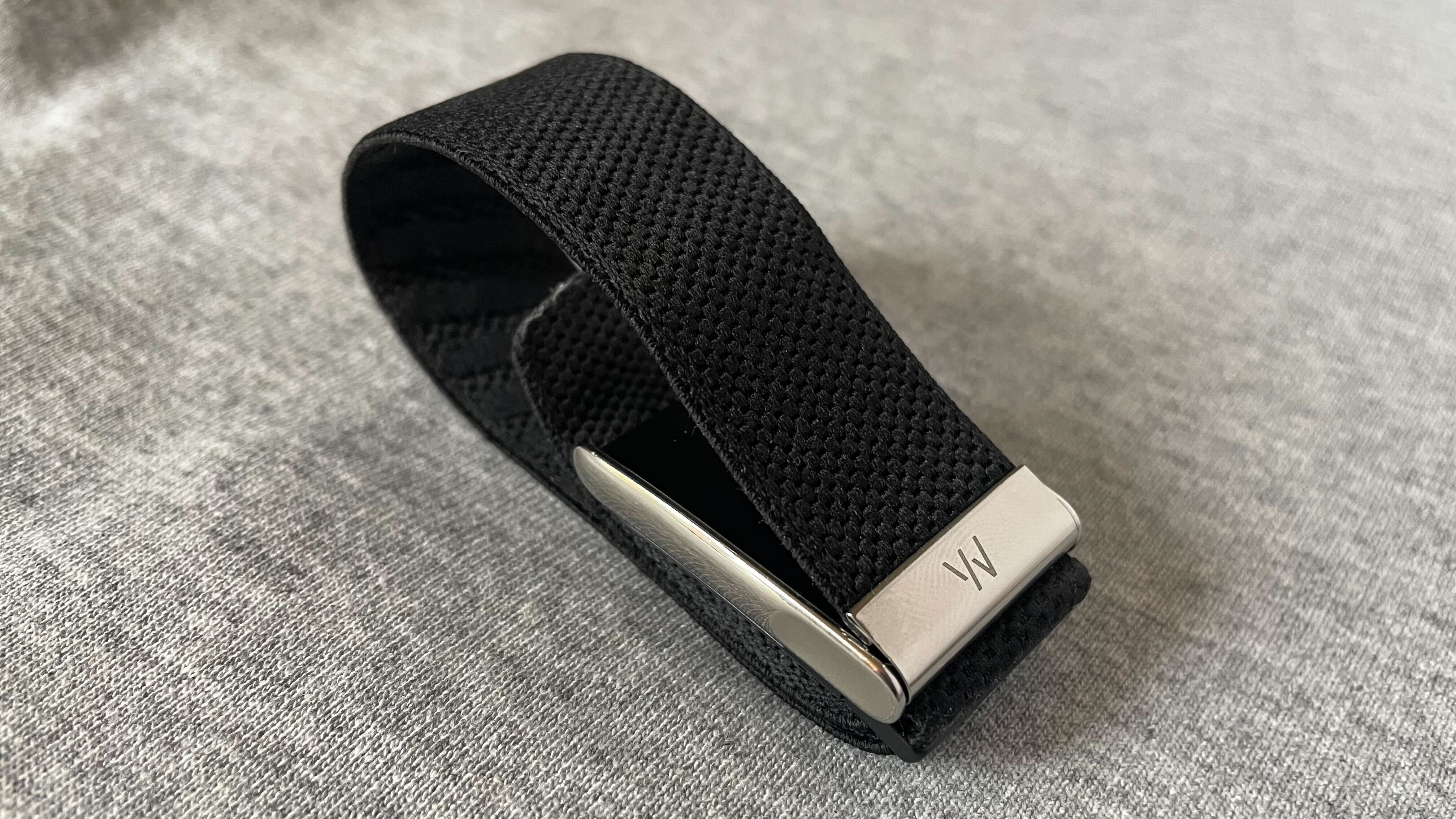 The Whoop MG fitness tracker showing its minimalist, screen-free sensor module.