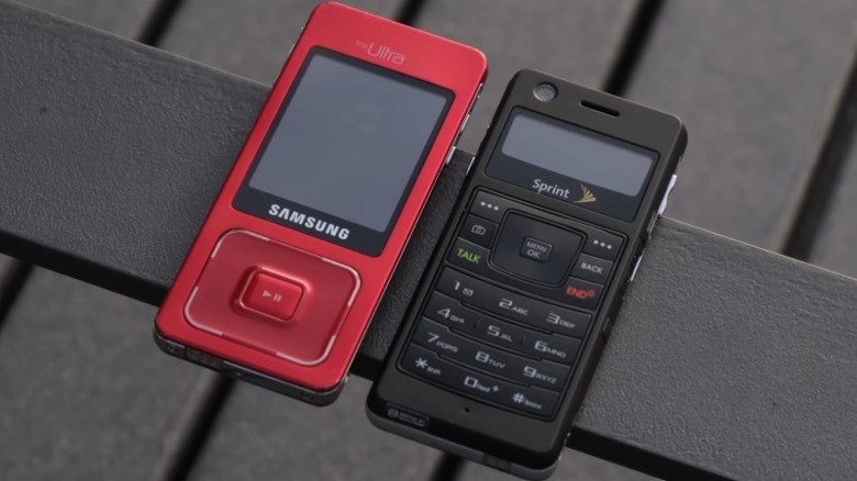 Two Samsung Galaxy UpStage phones, one showing the red music side and the other showing the black phone side.