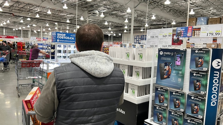 The electronics and cellphone kiosk area inside a Costco warehouse.