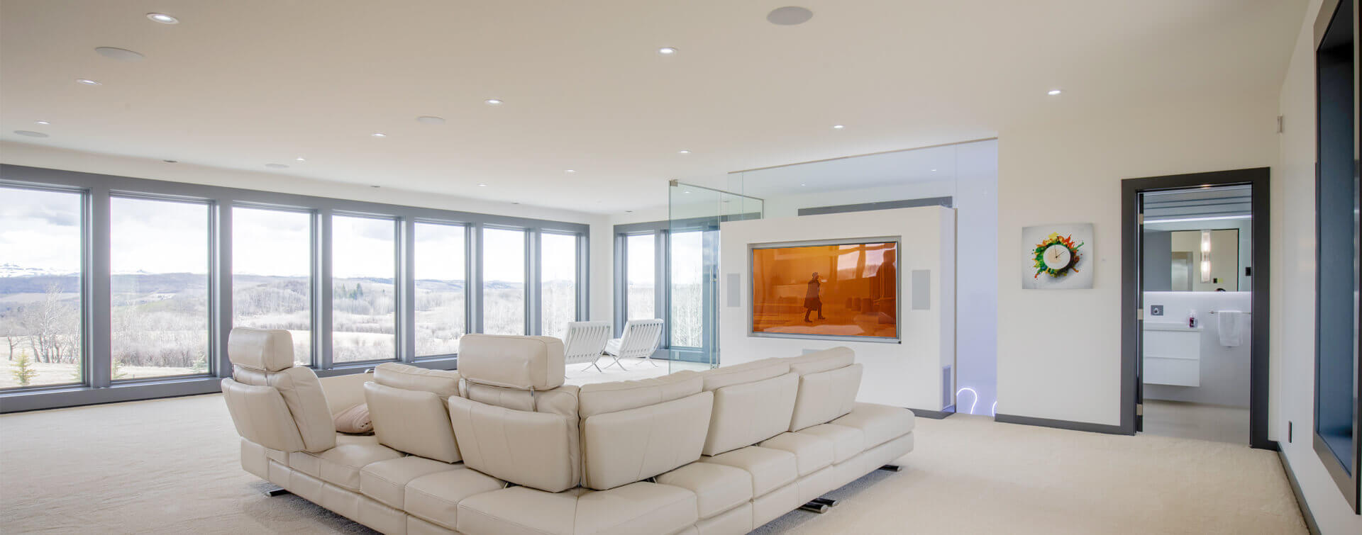 Modern living room featuring a Monitor Audio home cinema system with integrated ceiling speakers.