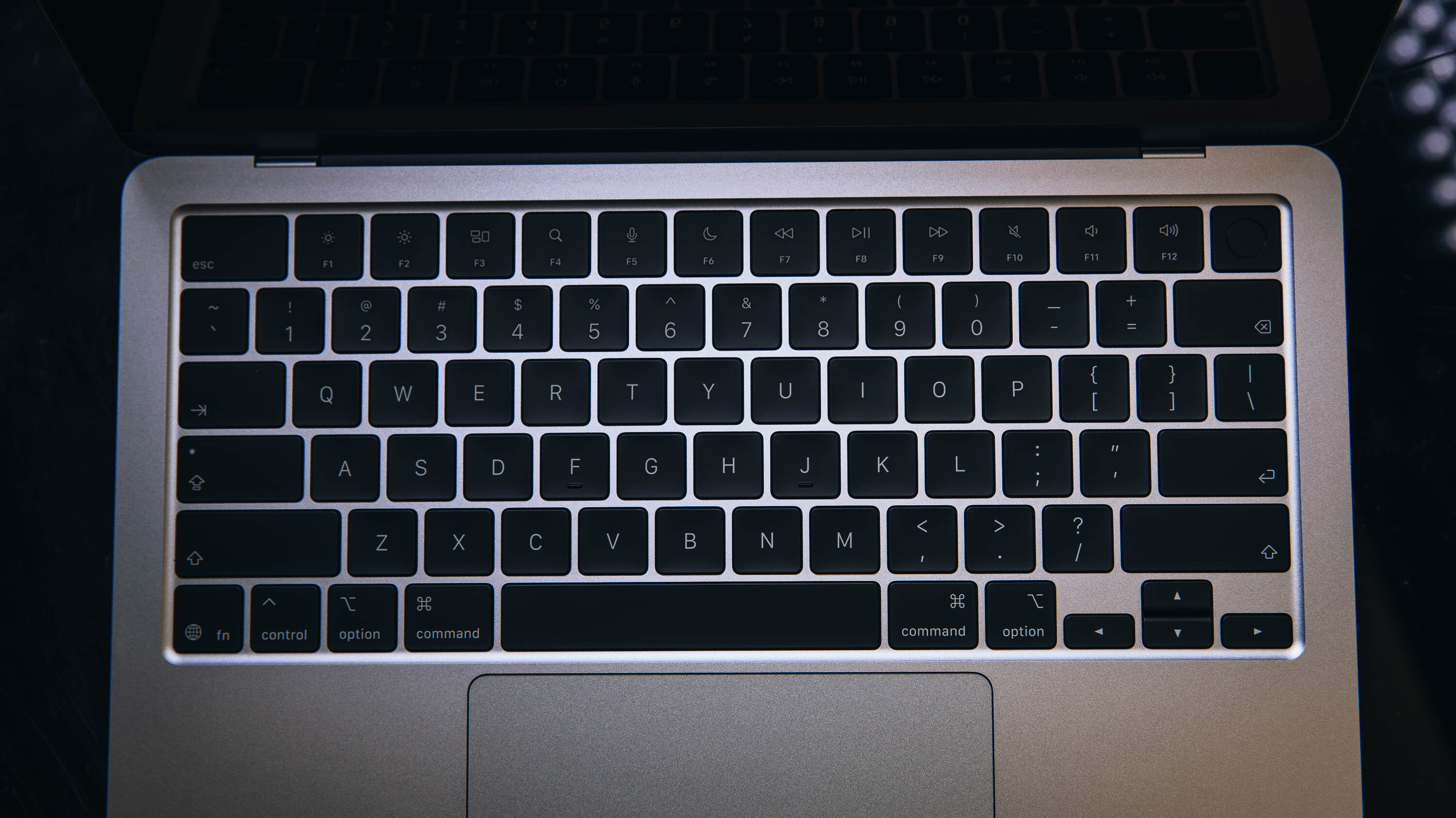 Closed MacBook Air showing its extremely thin aluminum chassis from a side angle.