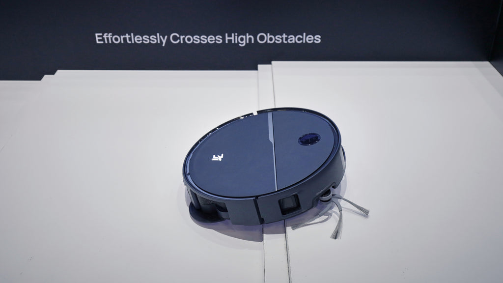 A 3i Q10 Ultra robot vacuum climbing over a high wooden step in a demonstration area.