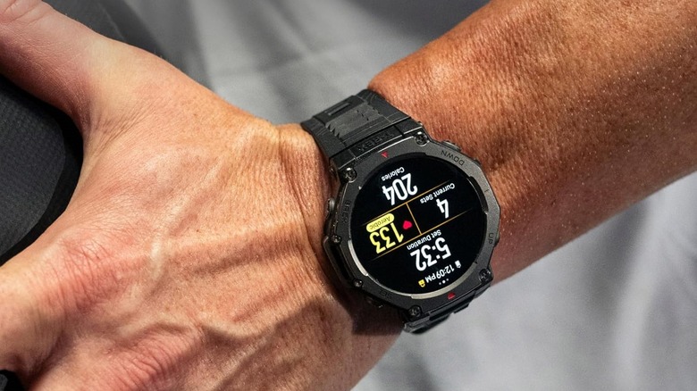 Close-up of the rugged Amazfit T-Rex 3 on a man's wrist outdoors.