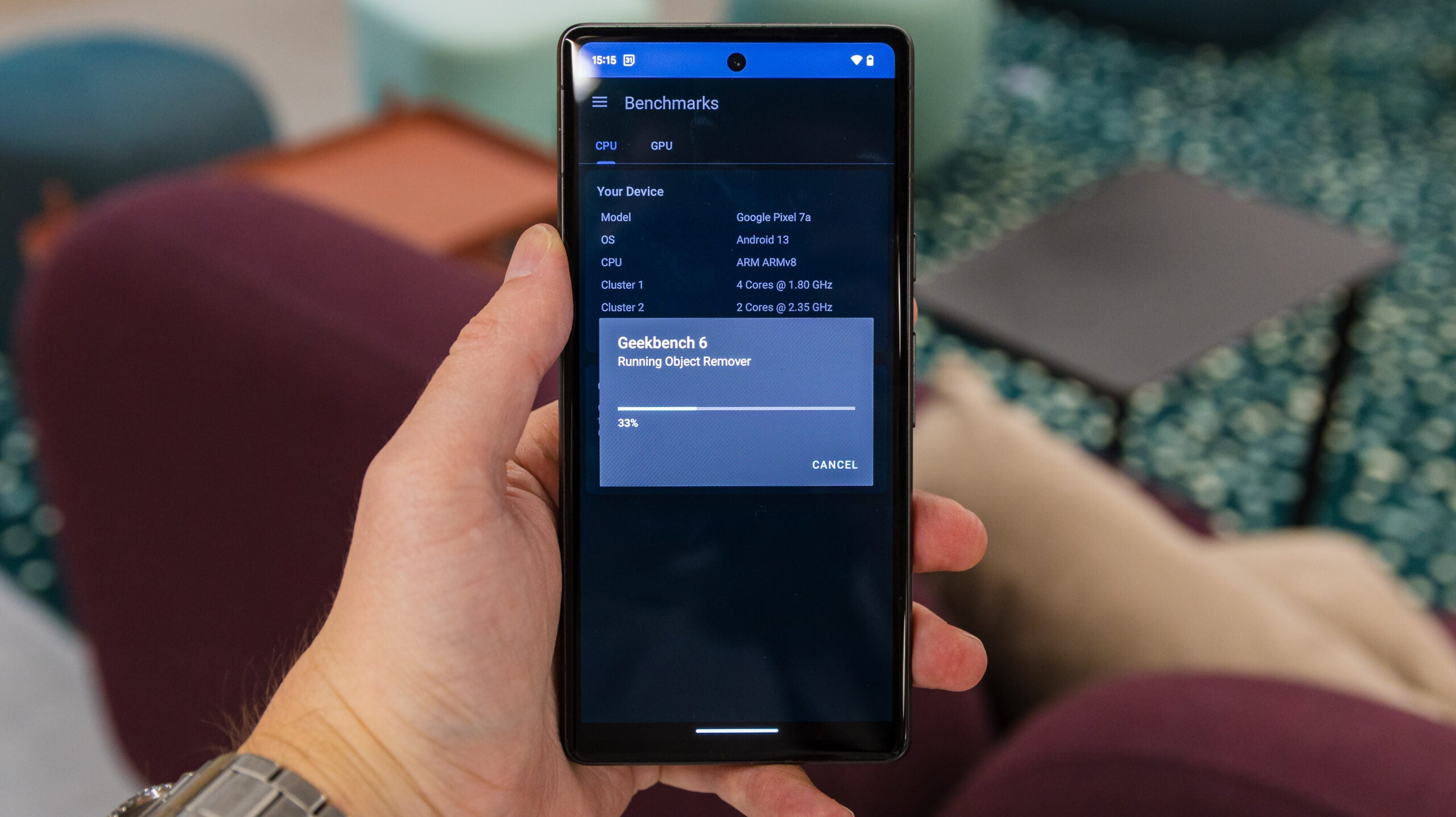 A technician testing a smartphone using software to measure performance metrics.