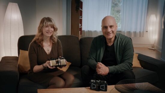 Charys Schuler and Marwan El Mozayen holding the WideluxX prototype alongside an original Widelux F8.