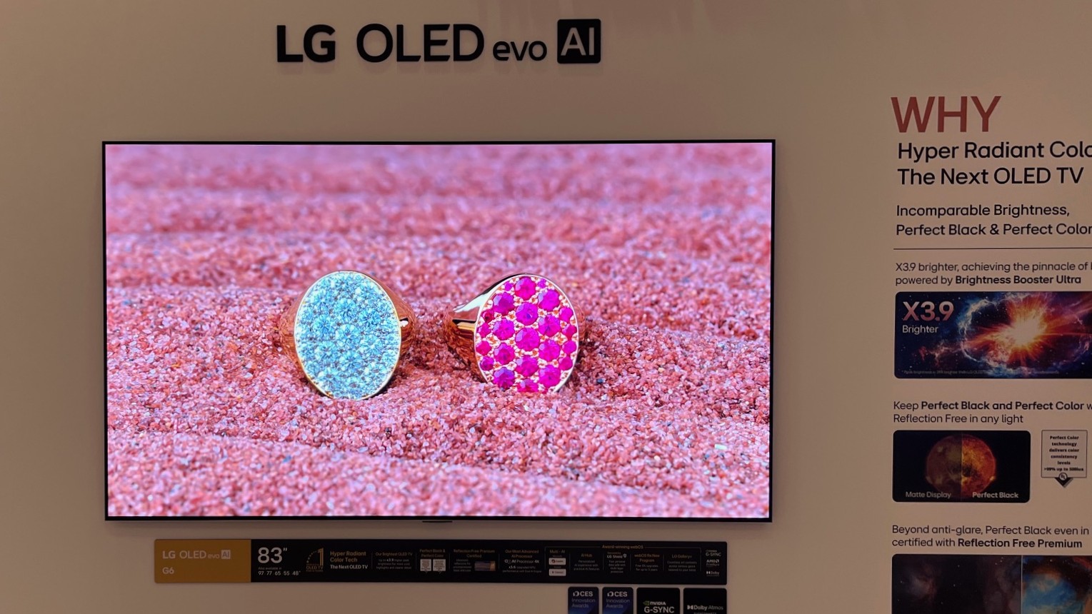 An LG OLED evo display showing highly detailed and bright jewelry against a vivid pink backdrop.