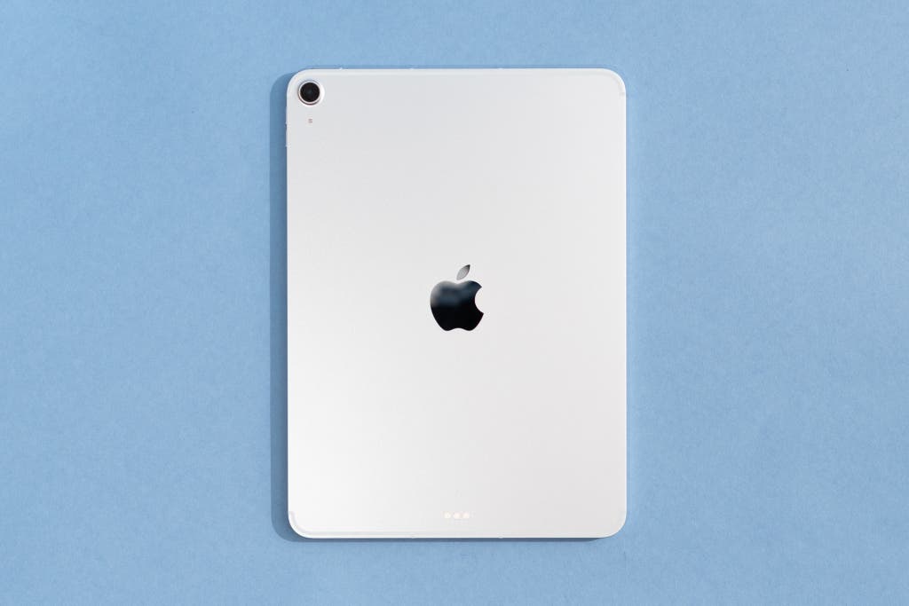 The back of a white Apple iPad Air M3 showing the single camera lens and Apple logo.