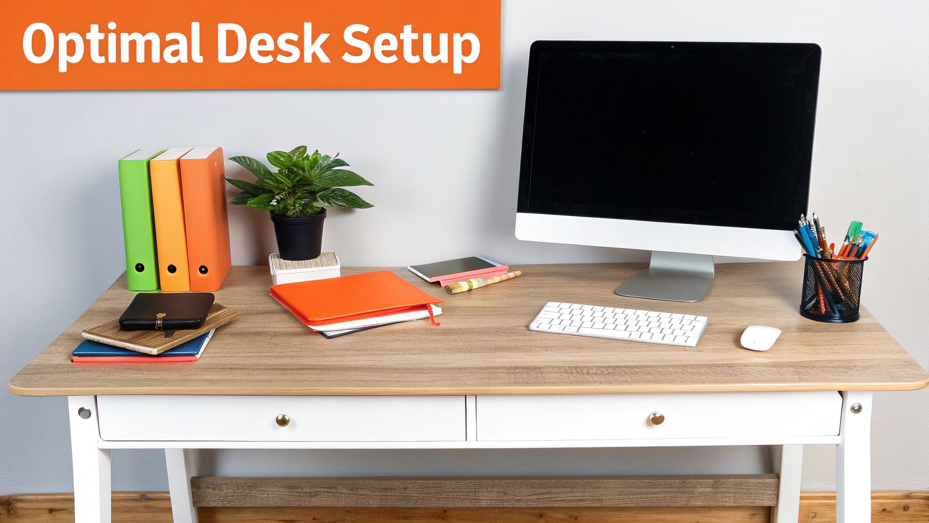 A high-angle view of a clean desk with a laptop, monitor, and phone organized by frequency of use.