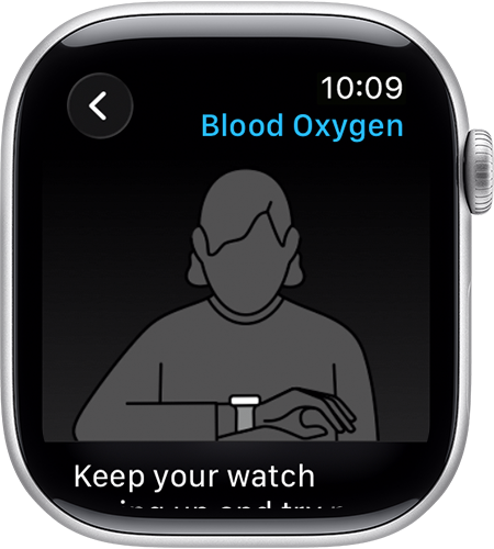 A person resting their arm flat on a wooden table while wearing an Apple Watch.