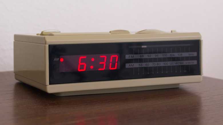A vintage digital flip-style clock radio from the transition era of electronics.