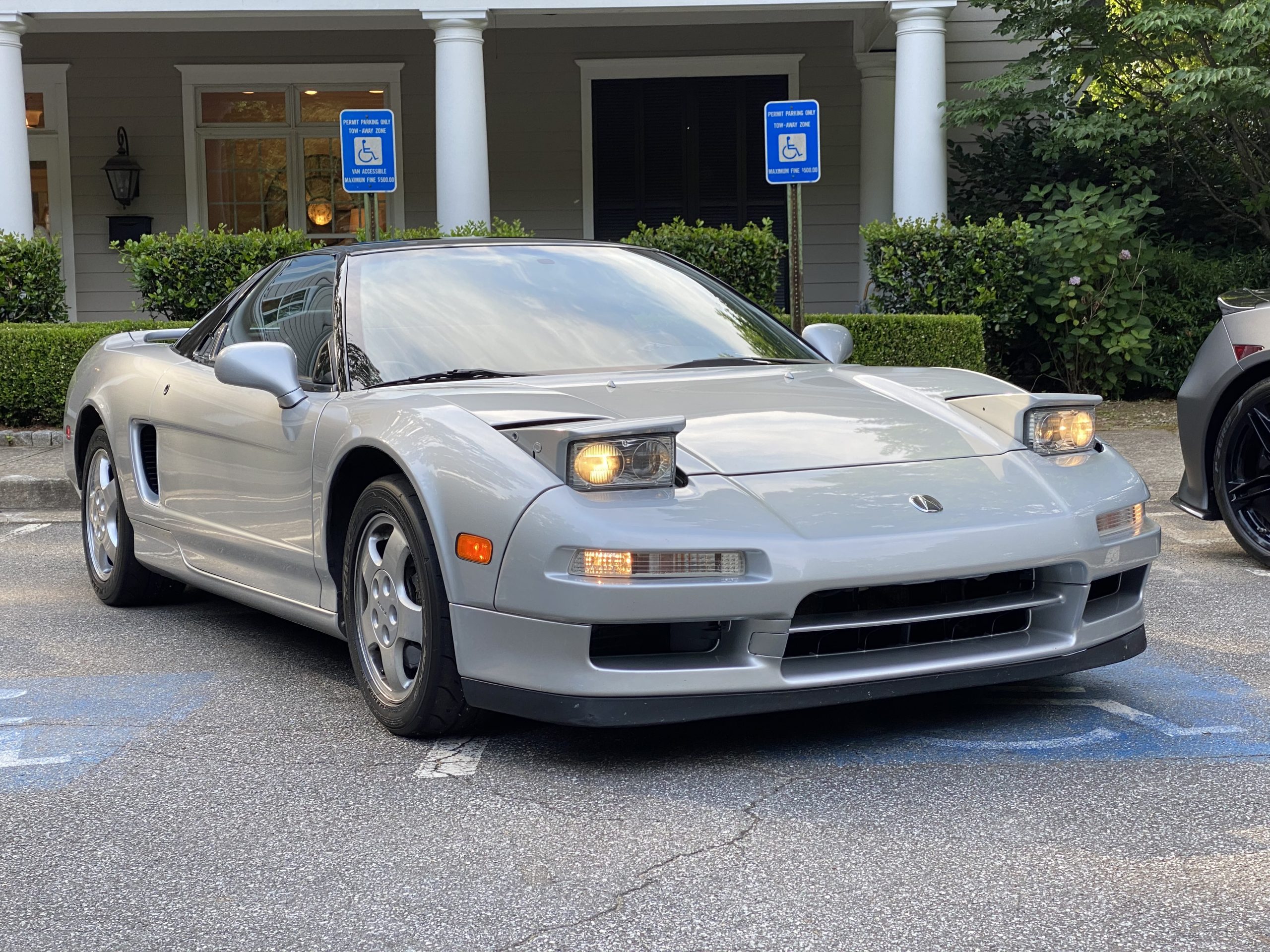 Interior view from the driver's seat of an NSX showing the low dashboard and expansive windshield.
