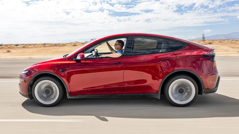 View from the driver's seat of a Tesla dashboard showing the vision-based environment mapping.