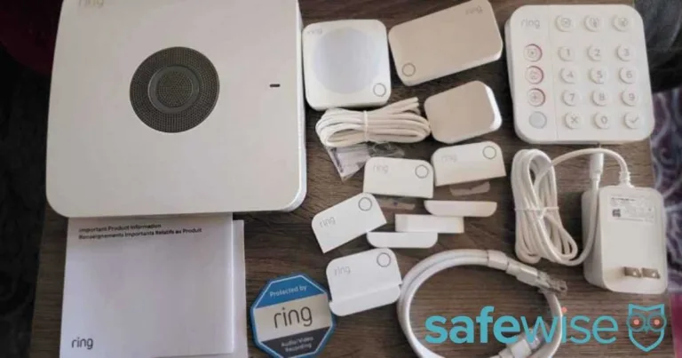 Unboxed components of a Ring Alarm security kit, including the base station and motion sensors.