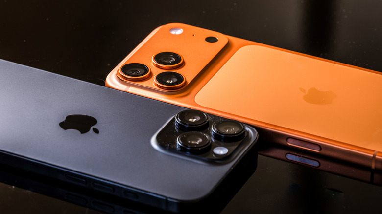 A side view profile of multiple iPhone 16 units showing the prominent protrusion of the camera lenses.