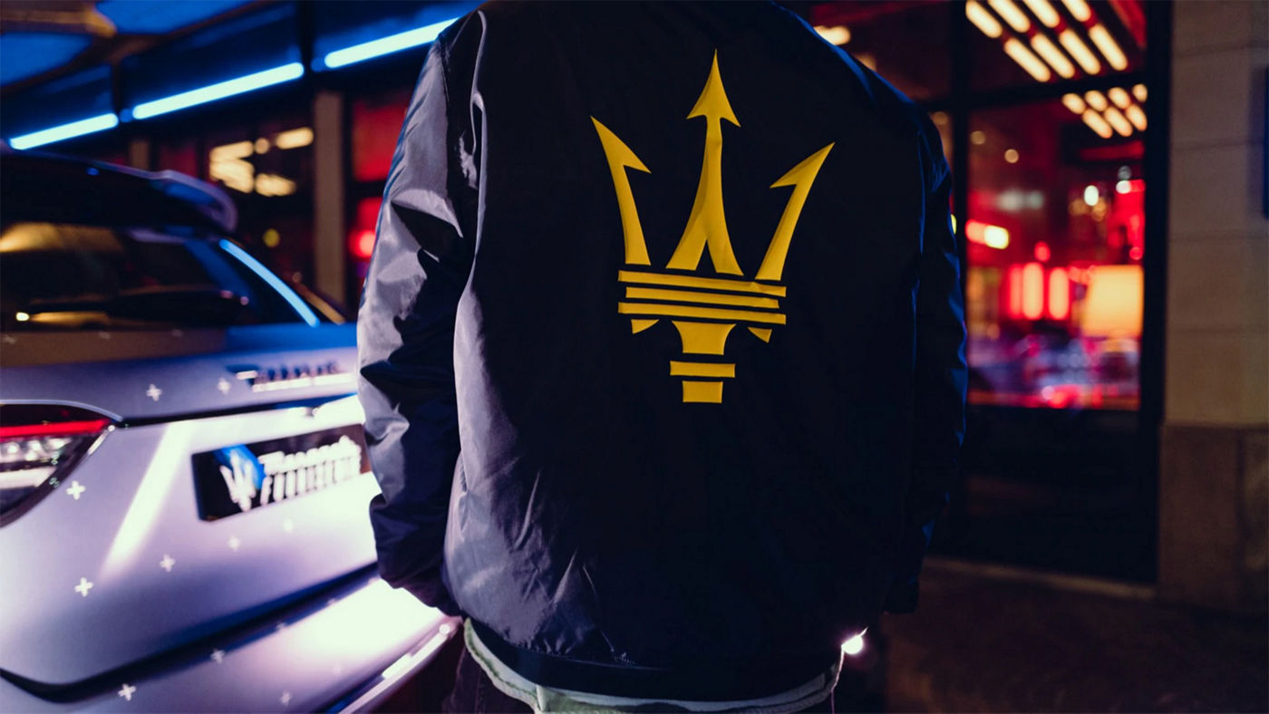 A gray Maserati Quattroporte Trofeo parked in a modern, minimalist garage.