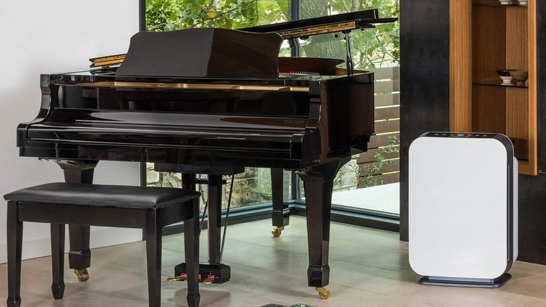 The Alen BreatheSmart 75i air purifier placed in a room next to a piano.