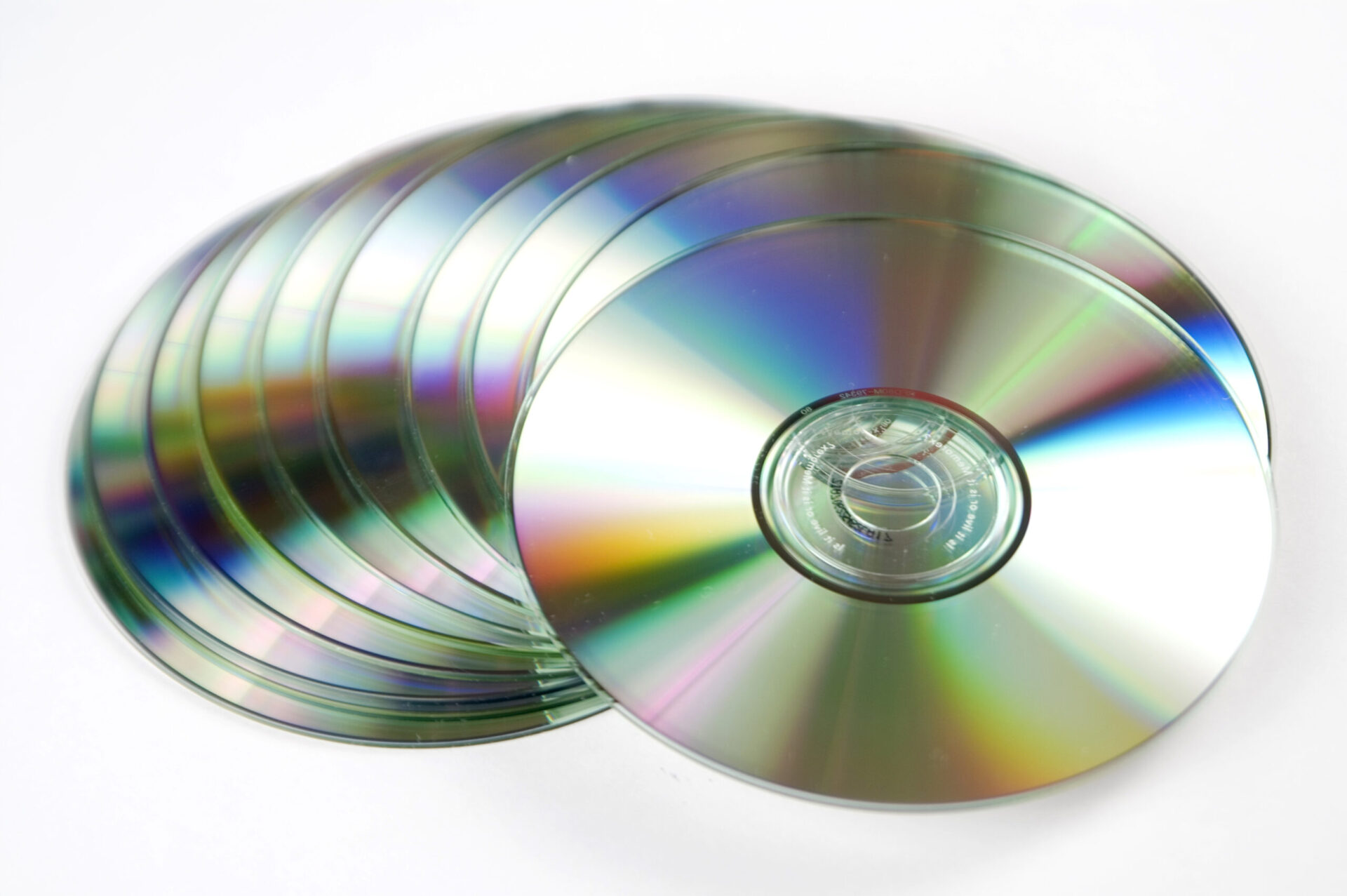 A collection of silver compact discs arranged in a pattern.