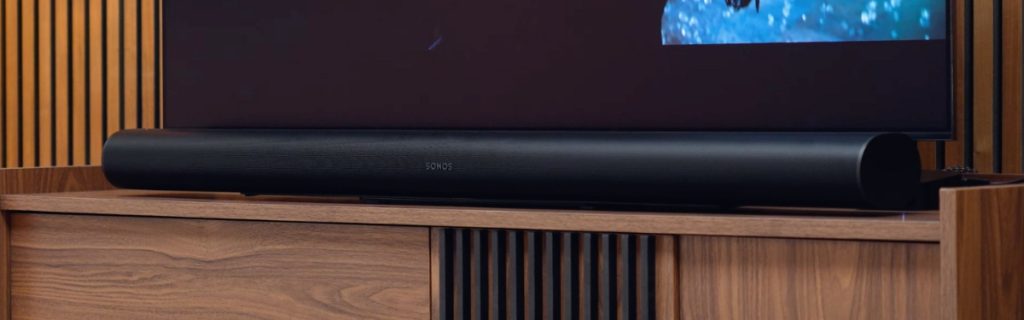 The Sonos Arc Ultra soundbar positioned neatly on a white media console.