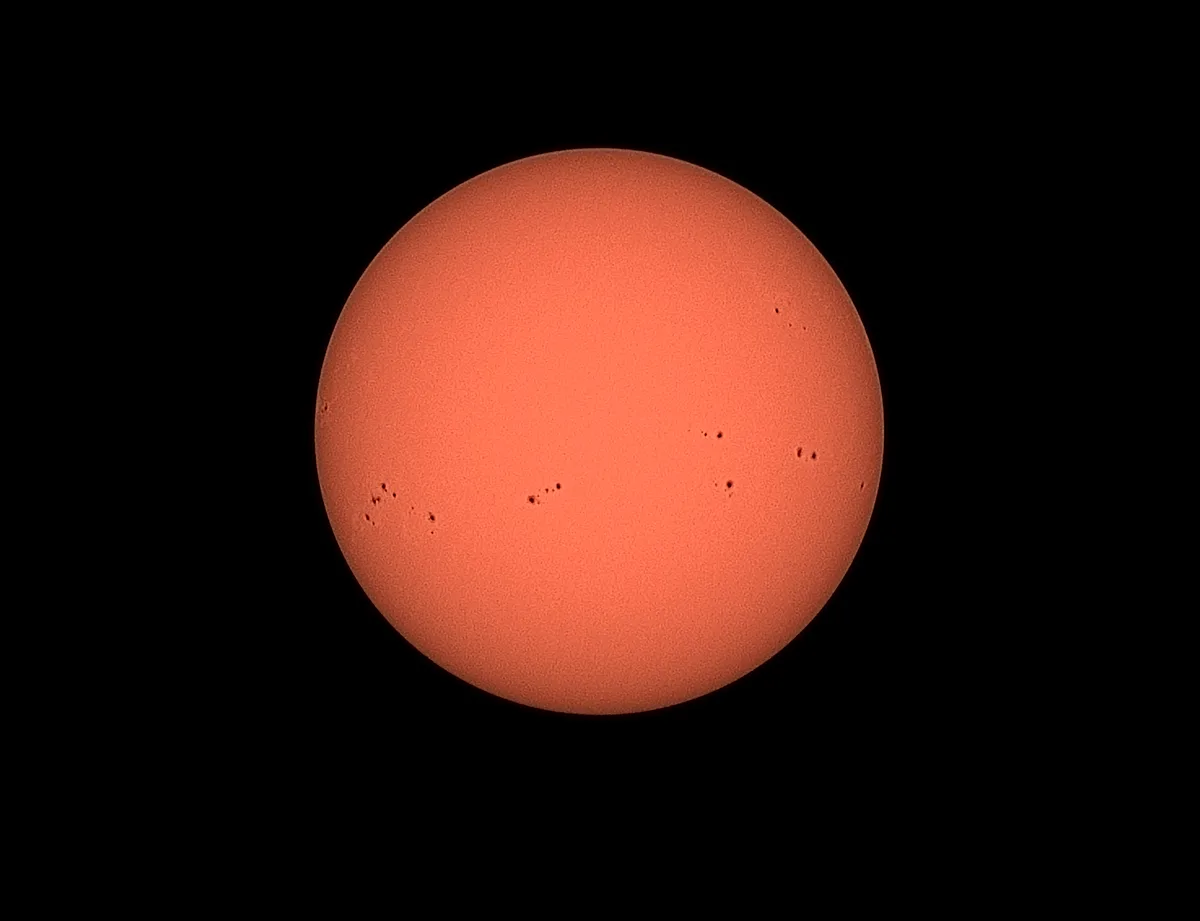A detailed image of the sun with visible sunspots captured by the Dwarf 3.
