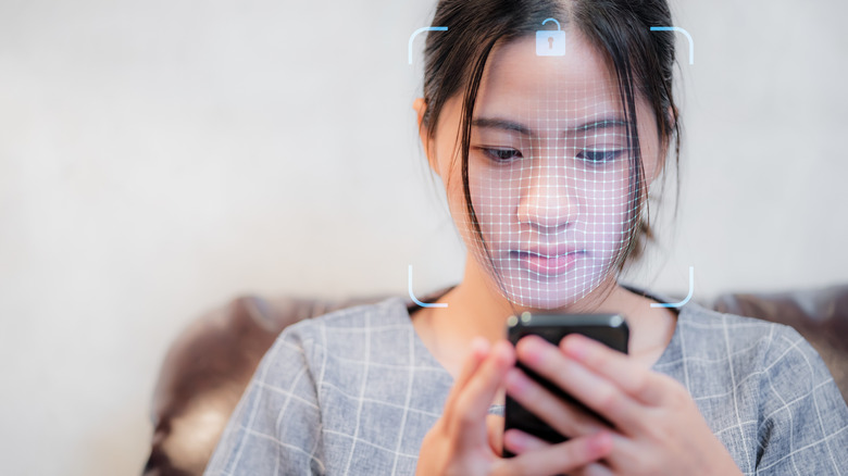 A visualization of a face being scanned by a smartphone using 3D facial recognition technology.