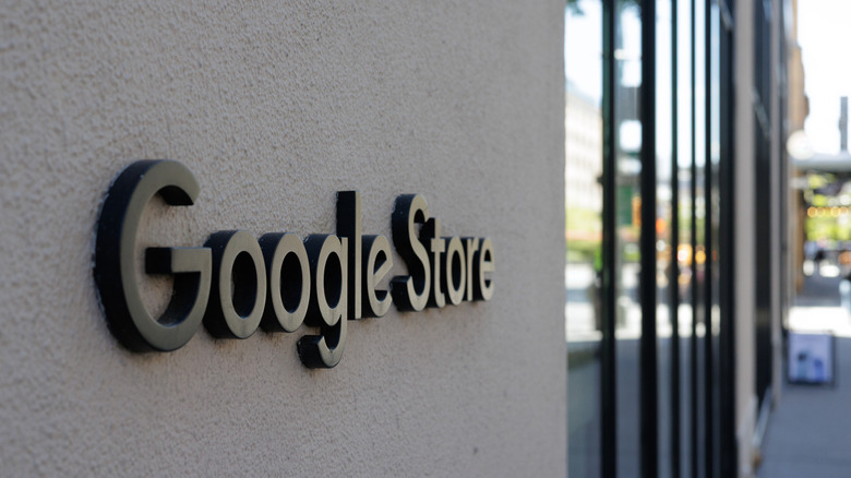 Close-up of the metallic Google logo at a physical store entrance.