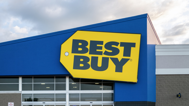 Exterior view of a Best Buy retail store entrance with the blue and yellow logo.