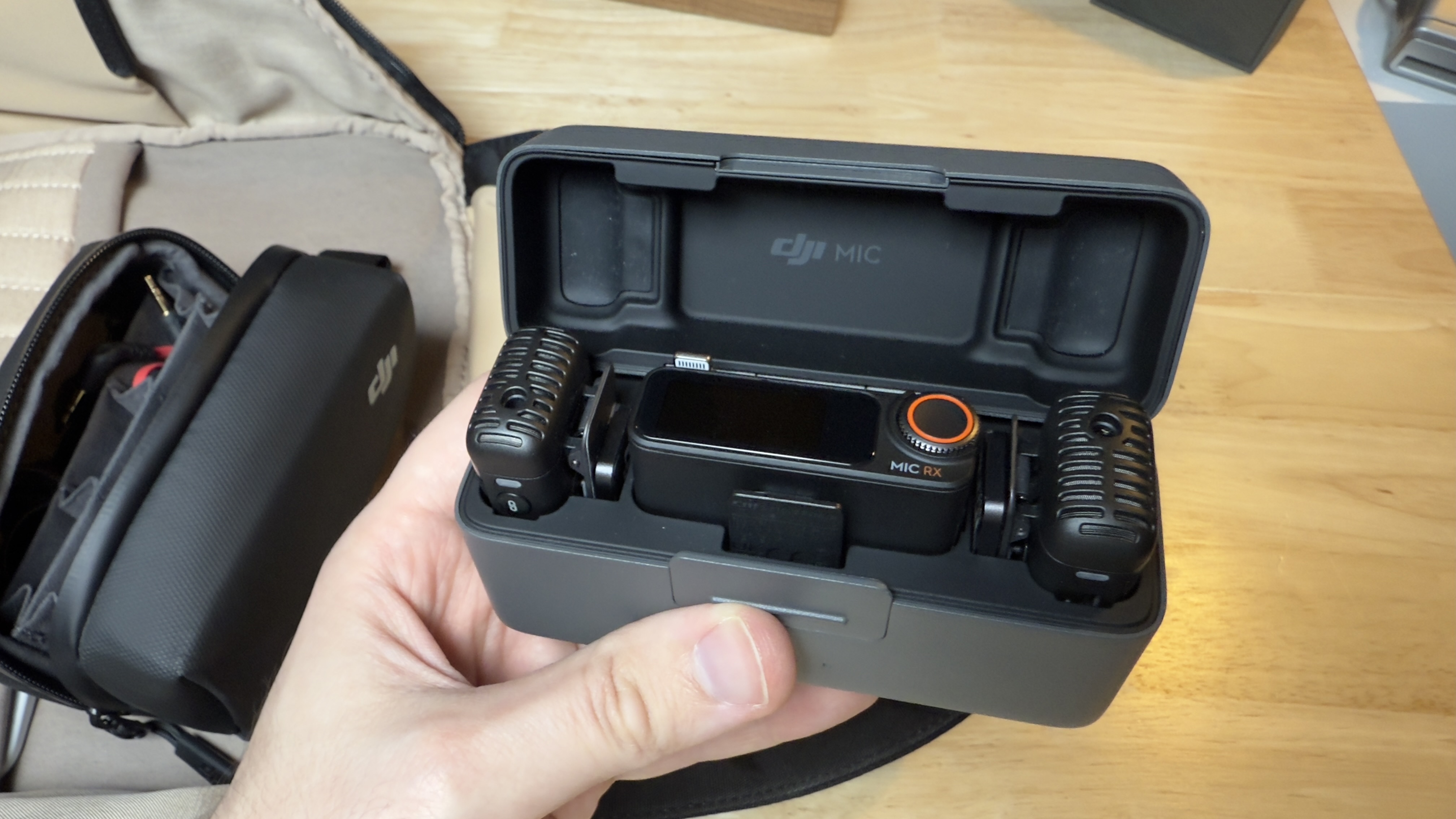The DJI Wireless Mic 2 transmitter and receiver inside their charging case.