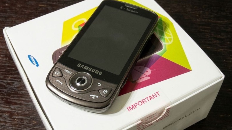 A Samsung Behold II smartphone resting on its original retail packaging.