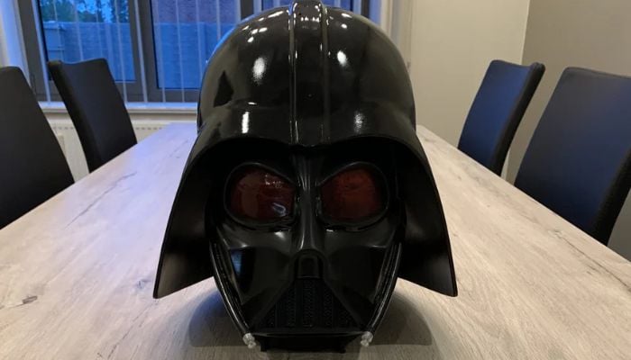 A life-sized, wearable 3D printed Darth Vader helmet shown in multiple assembly parts.