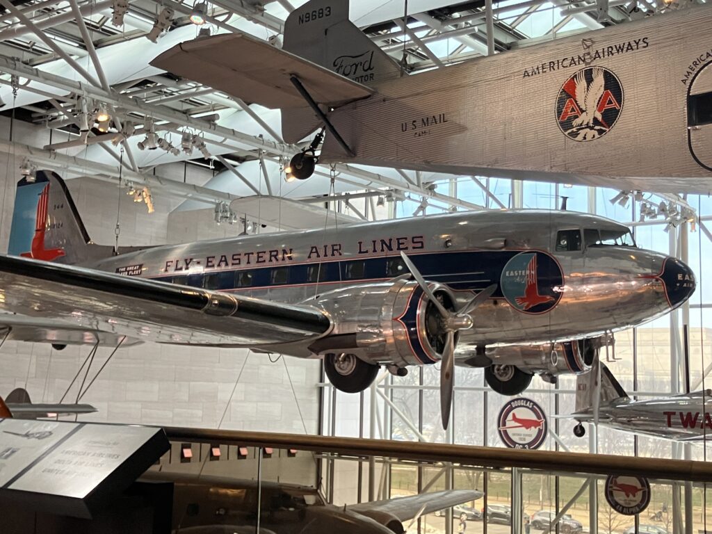 A vintage Eastern Air Lines passenger aircraft in a museum hangar.