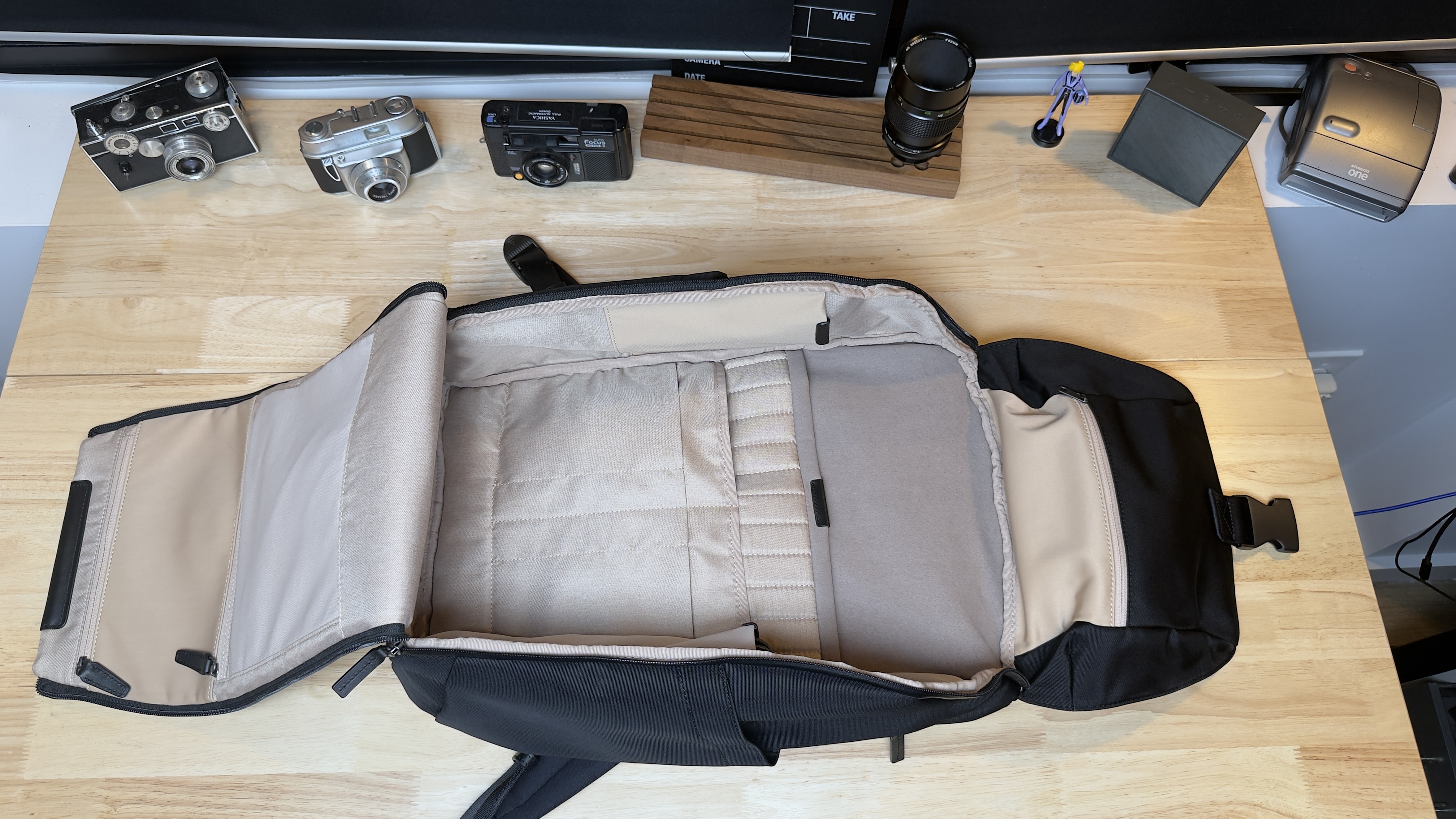 An open Stuart & Lau Capstone Backpack showing organized interior compartments.
