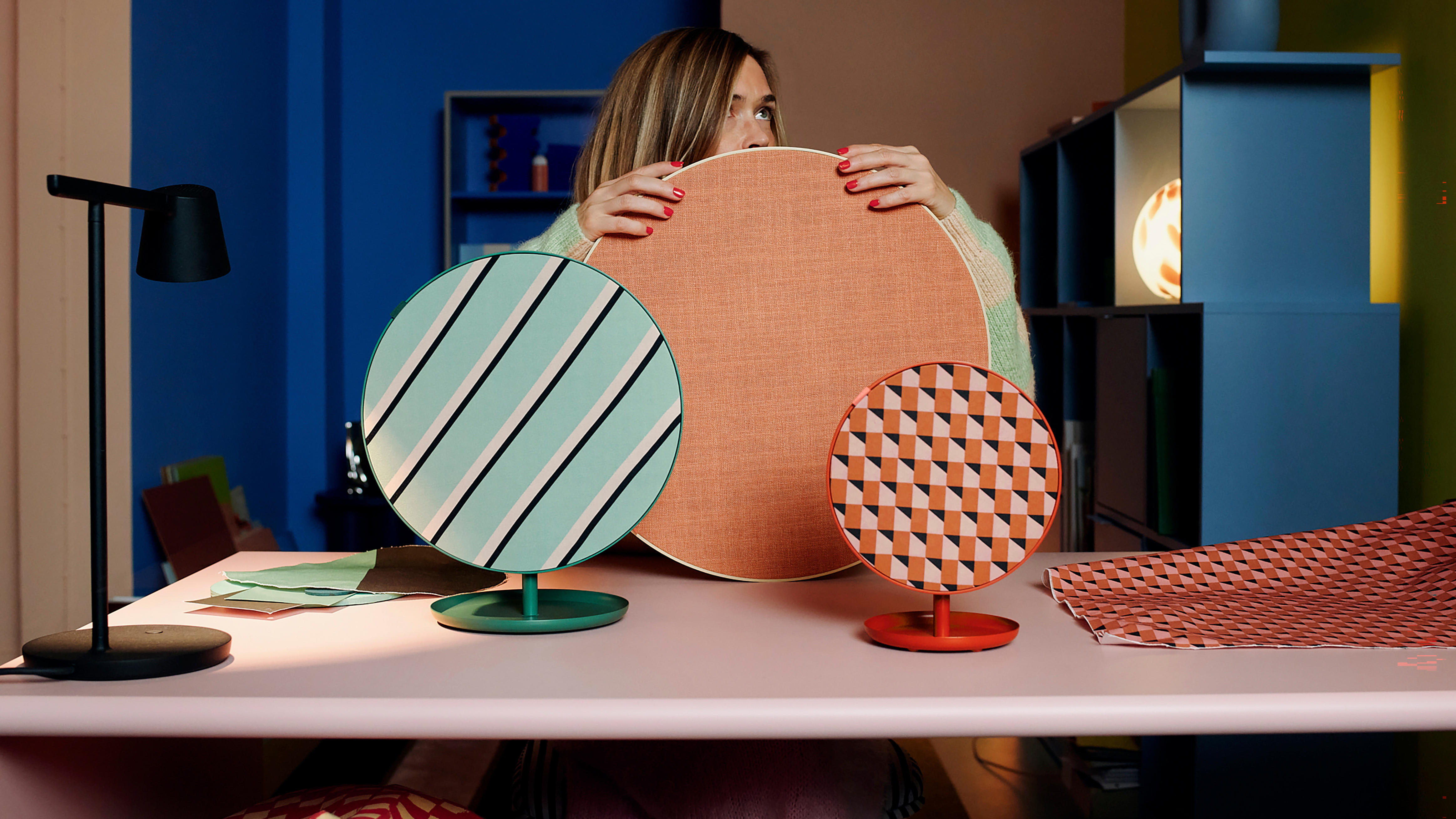 IKEA SOLSKYDD round Bluetooth speakers with vibrant orange and green geometric patterns.