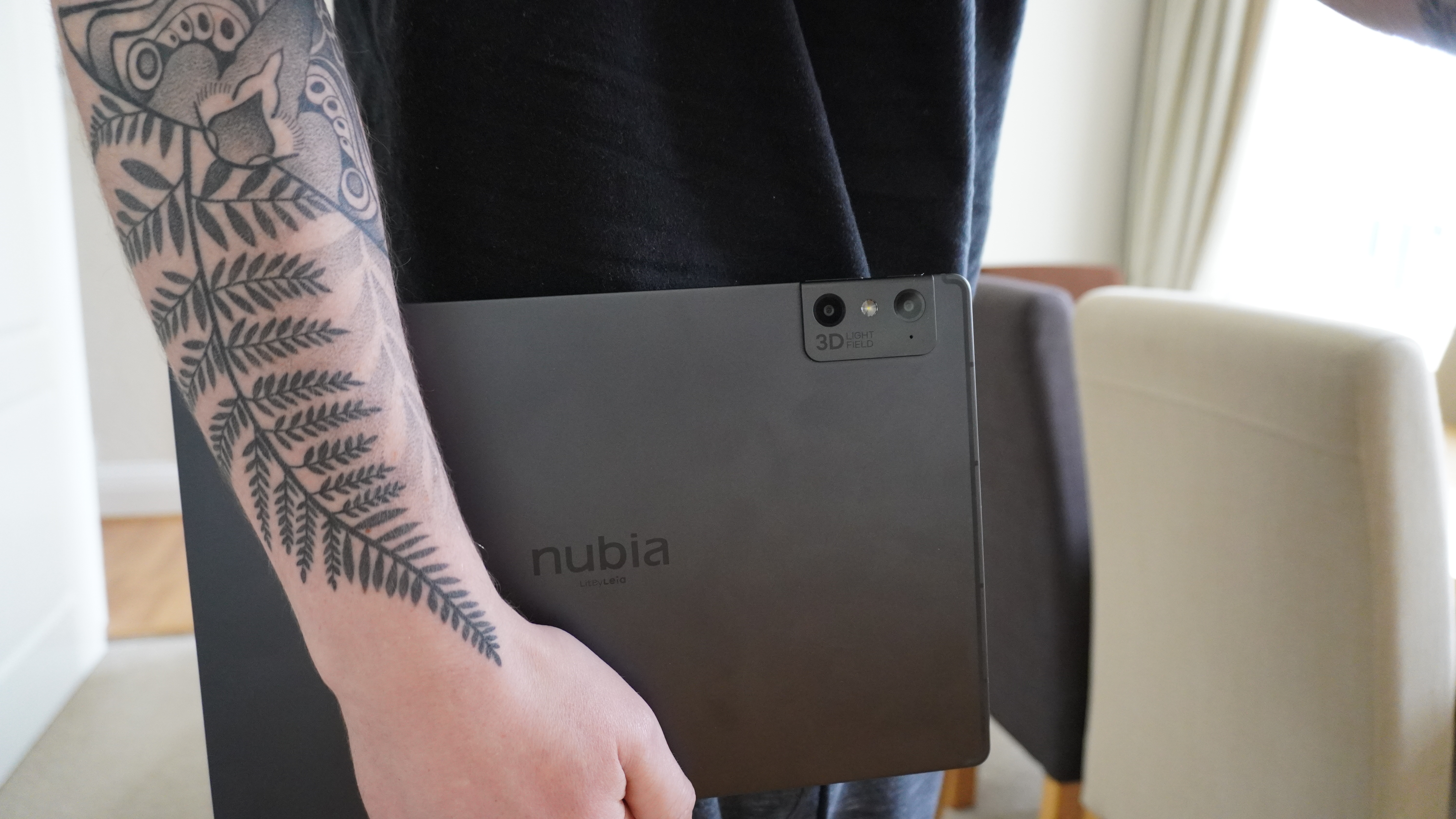 A person holding the 12.1-inch Nubia Pad 3D II tablet.