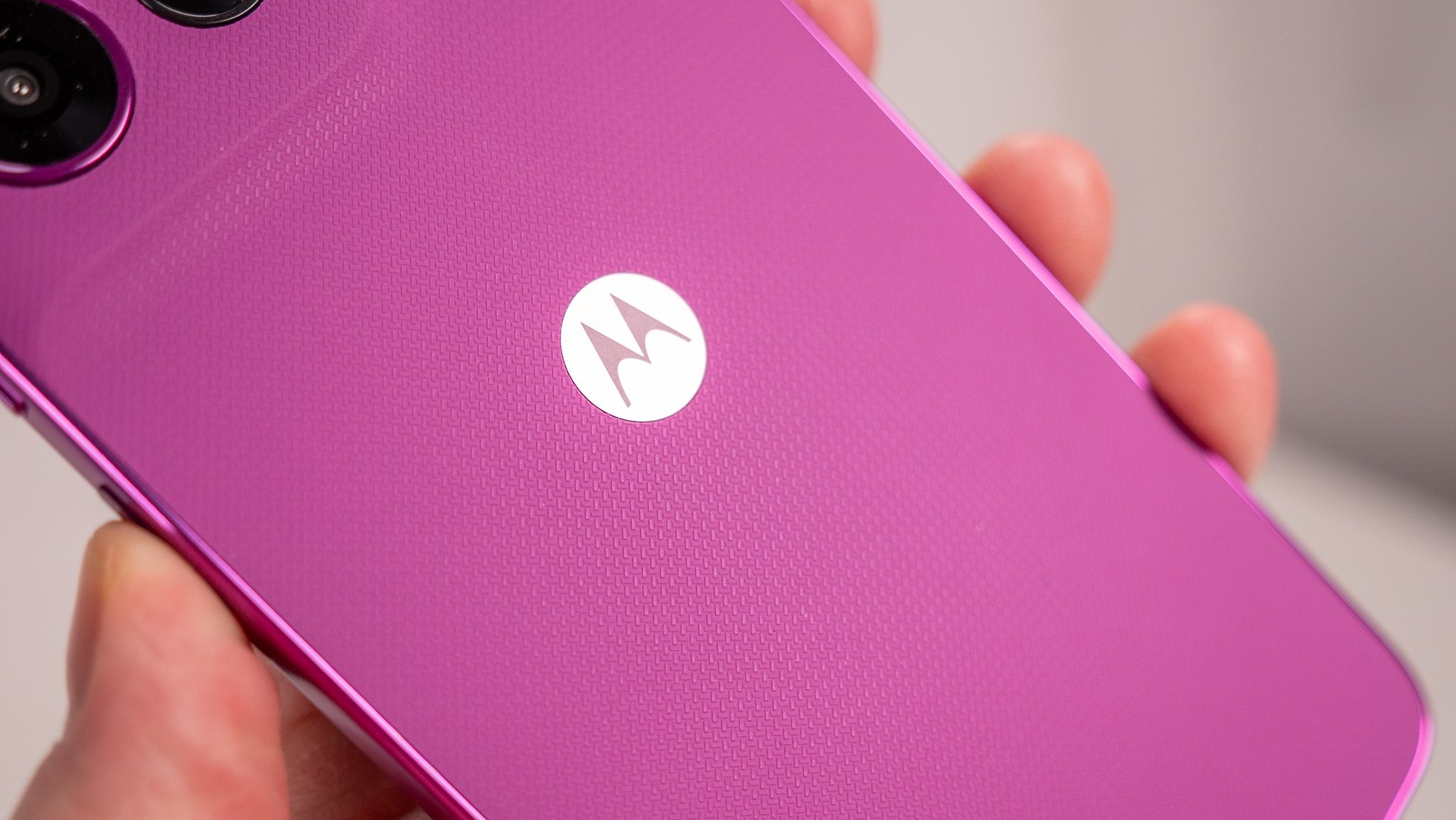Handheld photo of the pink Moto G 2026 in Cattleya Orchid.