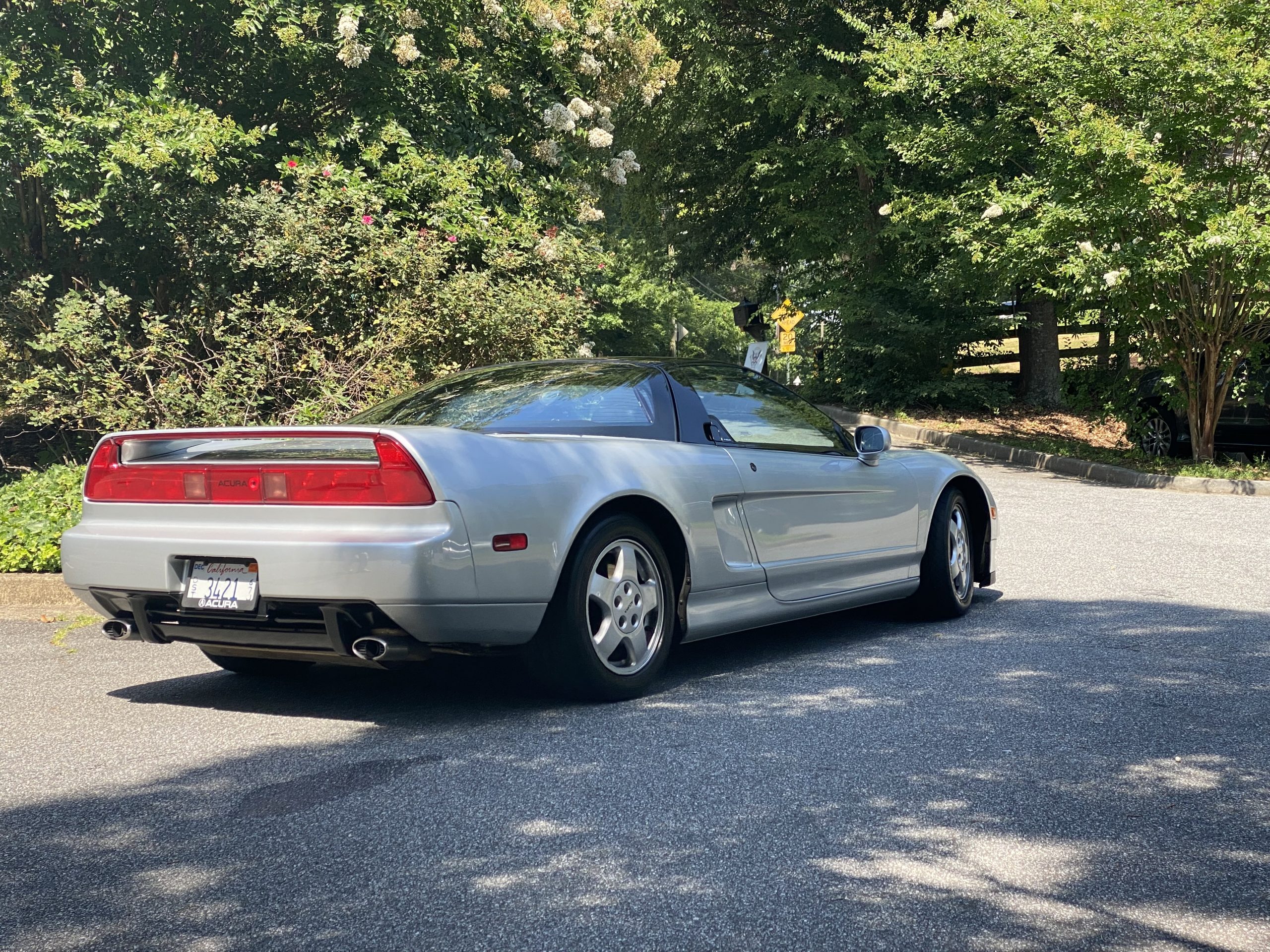 Clean side profile view of a silver first-generation Acura NSX.