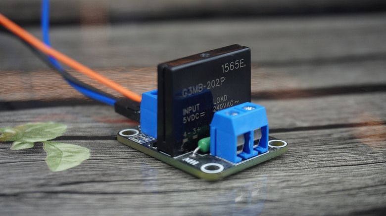A black Solid State Relay component with terminal connections