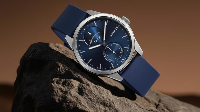 Withings ScanWatch 2 with a blue dial displayed on a rock.