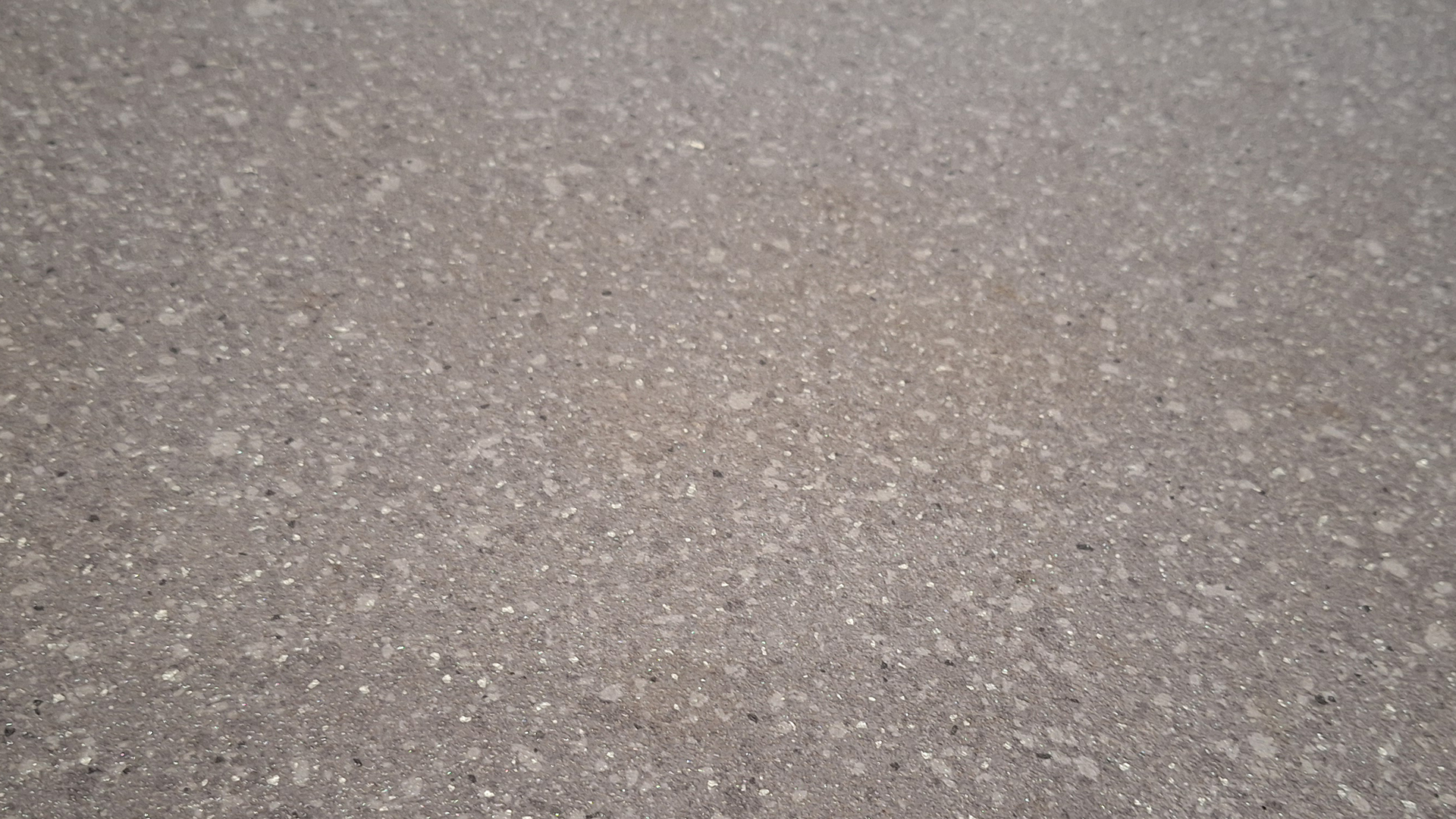 The same floor area showing a significantly cleaner surface after two passes by the robot.