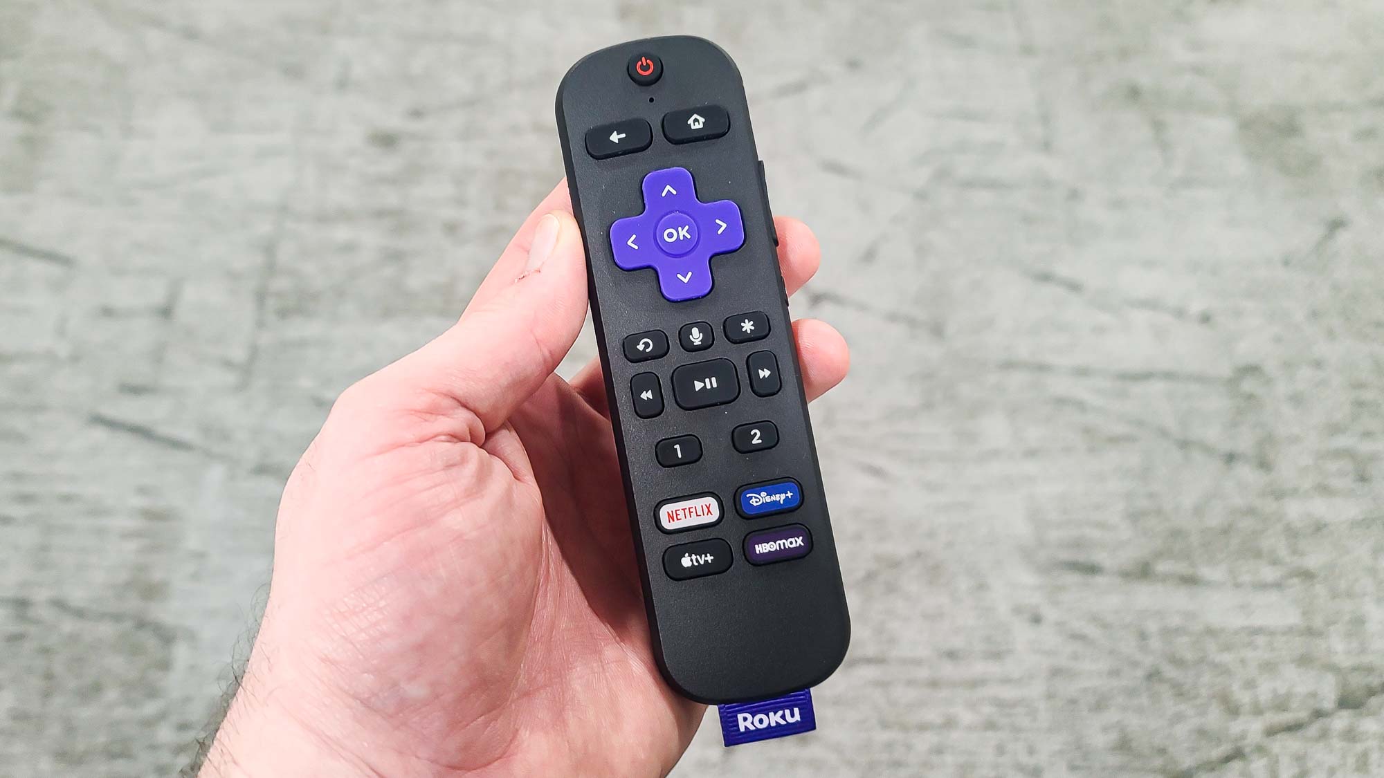 Close-up of a Roku Plus Series voice remote featuring shortcut buttons and a voice search icon.