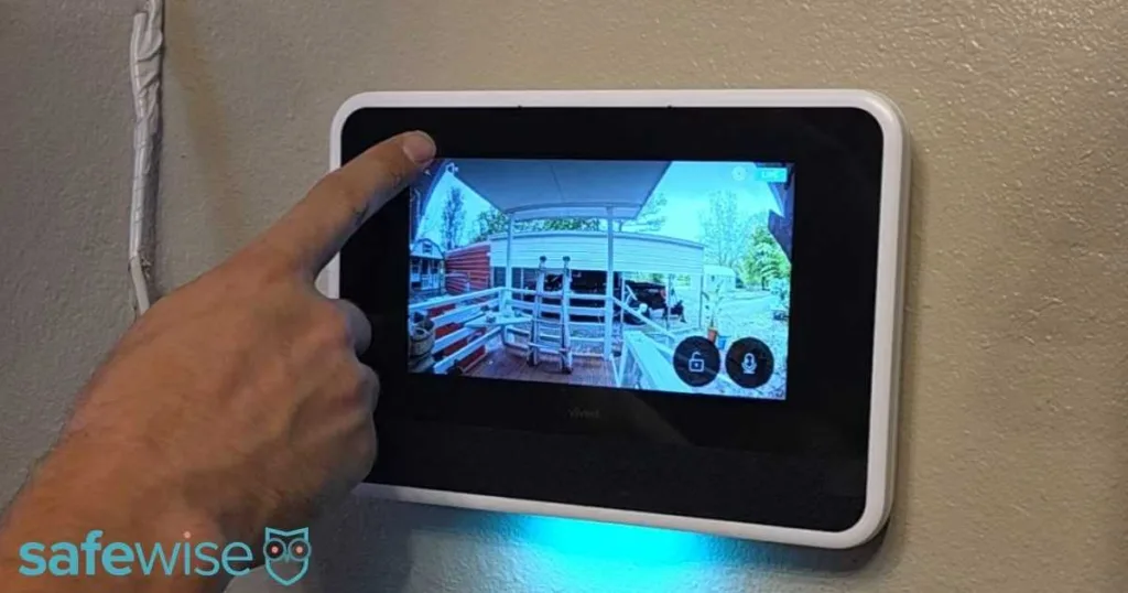 A wall-mounted Vivint control panel displaying a high-definition live security camera feed.