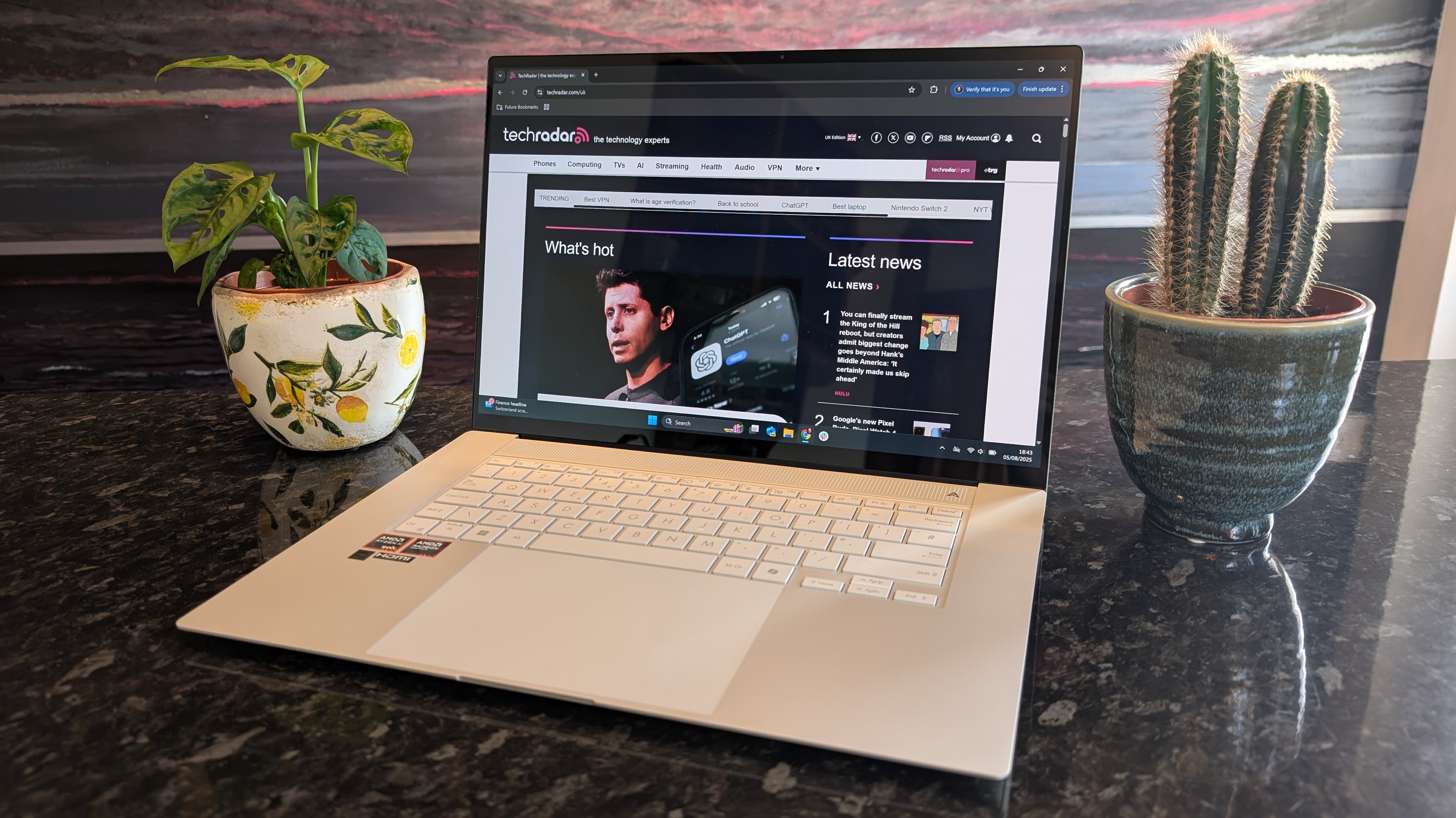 Asus Zenbook S 16 laptop on a dark marble surface.