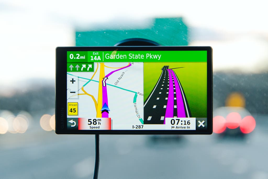 A GPS navigation device mounted on a car windshield