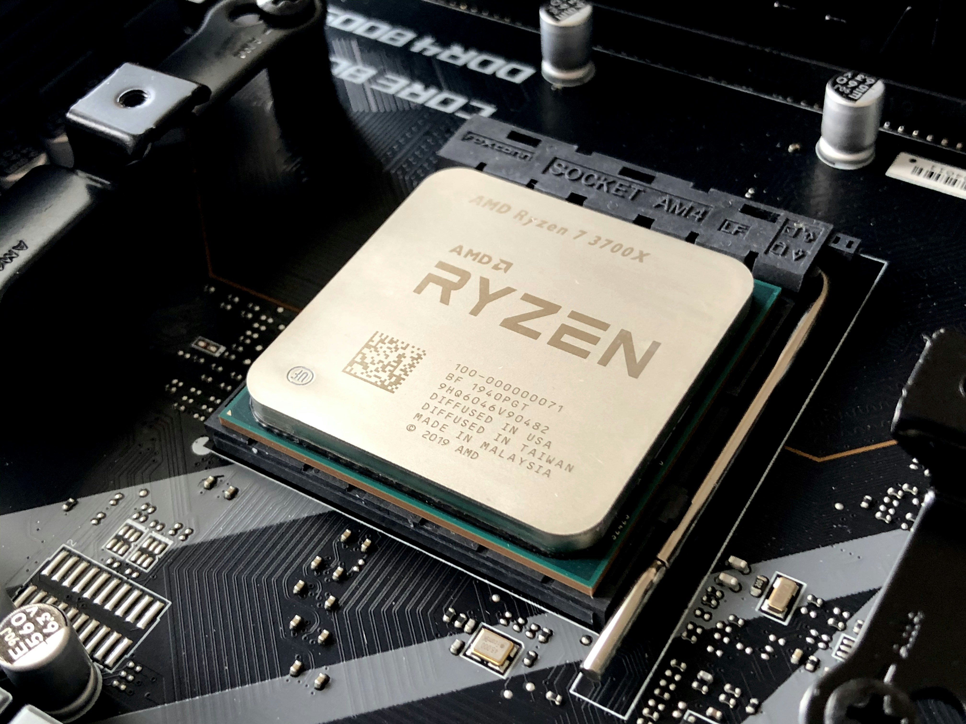 Internal view of a laptop showing the motherboard, copper heat pipes, and dual cooling fans.